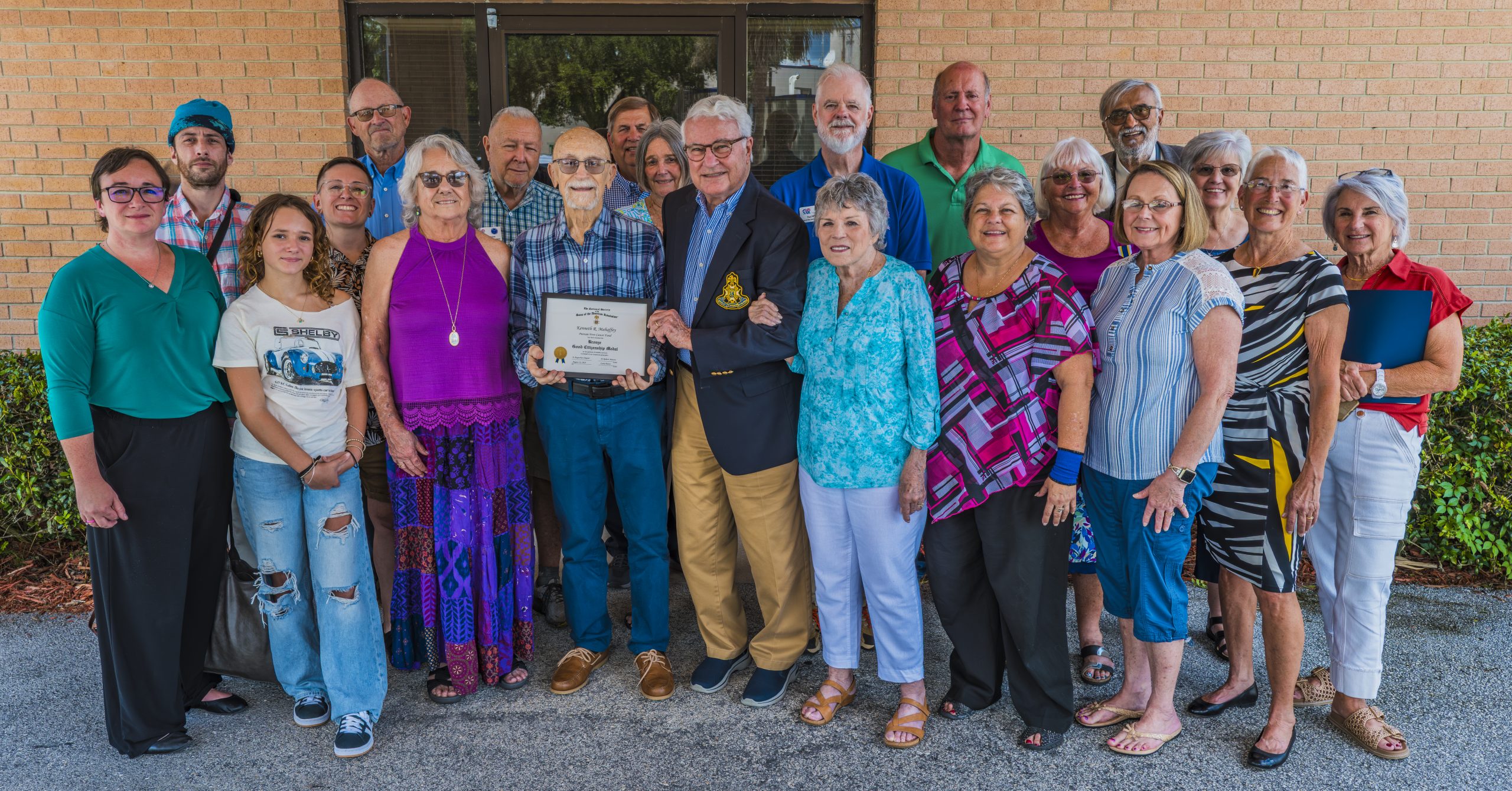 Capital City representatives give PFCF volunteers a $1,000 grant